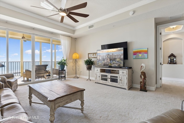 living room with carpet flooring, visible vents, baseboards, and a ceiling fan