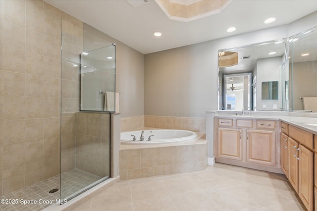 full bath with tile patterned flooring, a garden tub, double vanity, a stall shower, and a sink