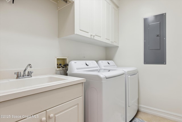 clothes washing area featuring electric panel, a sink, washer and dryer, cabinet space, and baseboards