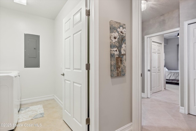 interior space featuring baseboards, laundry area, electric panel, light tile patterned flooring, and independent washer and dryer