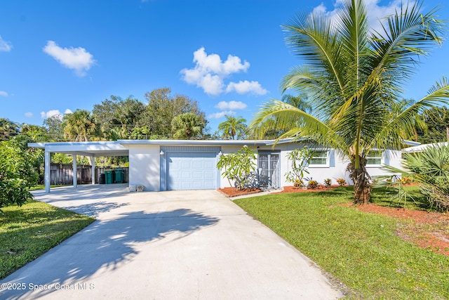 view of front of property featuring stucco siding, concrete driveway, a garage, a front yard, and a carport