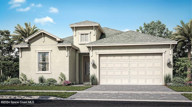 view of front of house featuring a garage, decorative driveway, and stucco siding