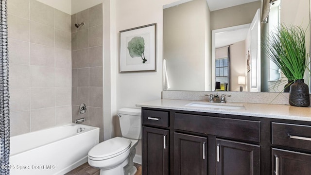 full bathroom featuring toilet, vanity, and shower / bathtub combination