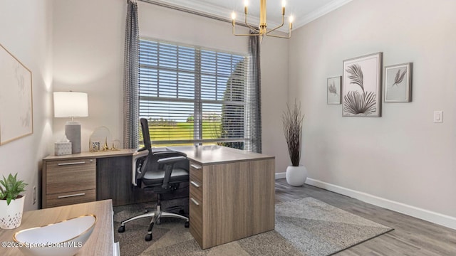 office space featuring baseboards, wood finished floors, a notable chandelier, and crown molding