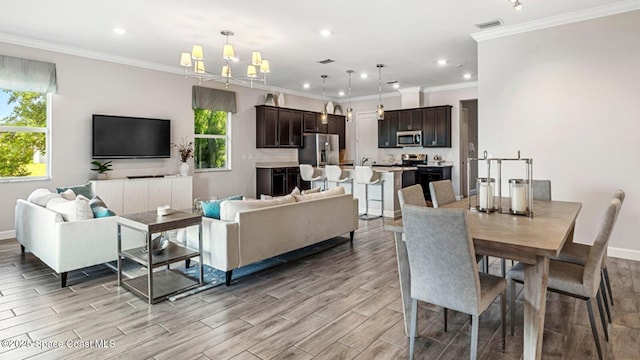 dining area with recessed lighting, ornamental molding, wood tiled floor, a chandelier, and baseboards