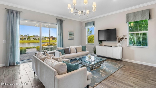 living room with crown molding, a notable chandelier, baseboards, and wood finished floors