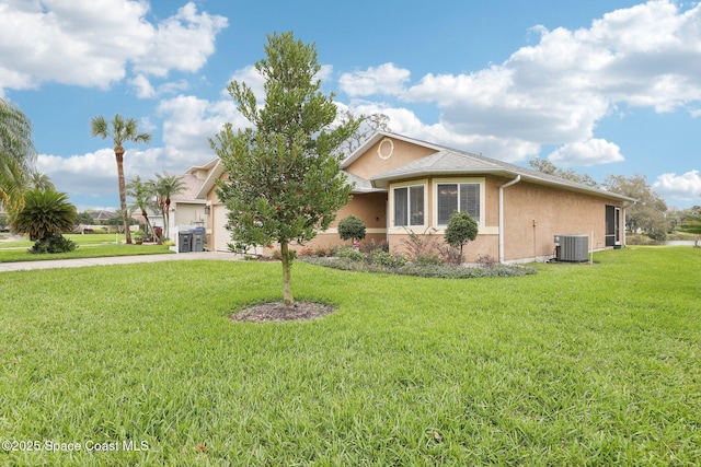 view of front facade featuring concrete driveway, an attached garage, cooling unit, a front lawn, and stucco siding