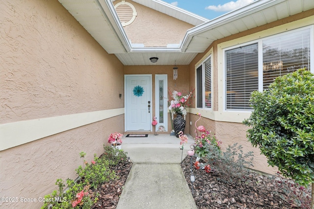 doorway to property with stucco siding