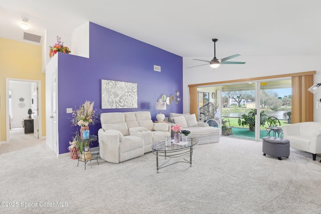 living area featuring carpet floors, visible vents, ceiling fan, and high vaulted ceiling