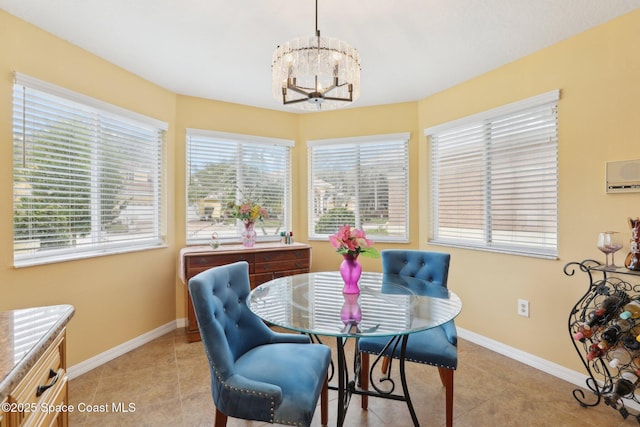 dining room with light tile patterned floors, a wall mounted air conditioner, baseboards, and an inviting chandelier