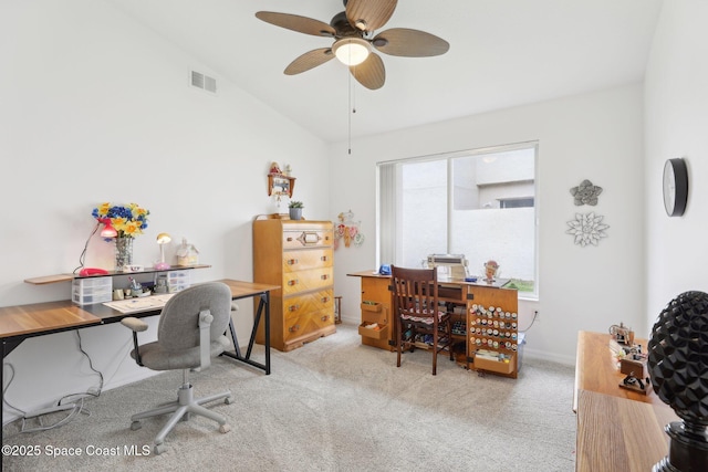 office featuring a ceiling fan, visible vents, vaulted ceiling, and carpet flooring