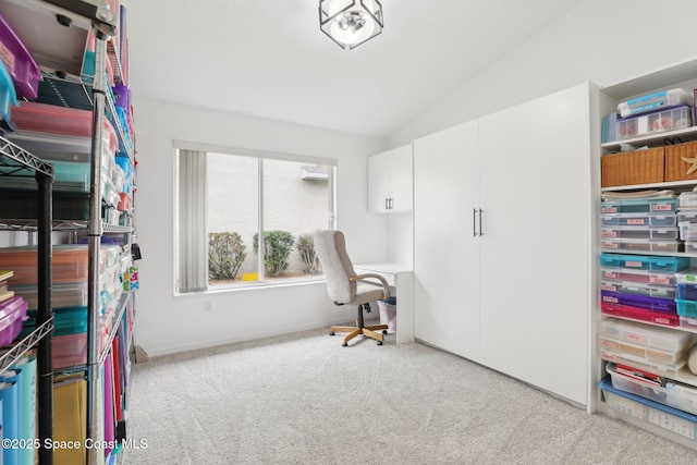 office area featuring carpet flooring, vaulted ceiling, and baseboards