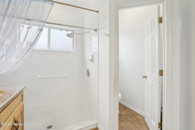 full bath with tile patterned floors, a shower stall, toilet, and vanity