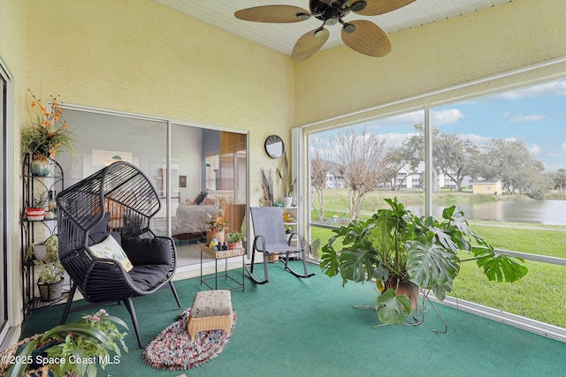 unfurnished sunroom with a water view and ceiling fan