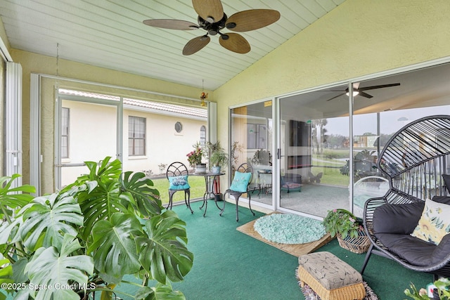 sunroom / solarium with vaulted ceiling and a ceiling fan