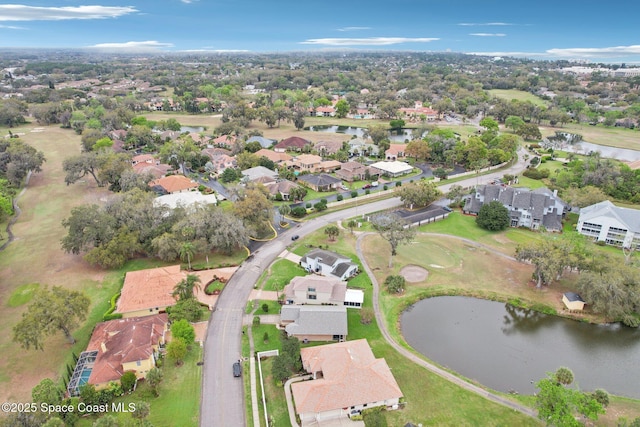 drone / aerial view with a water view and a residential view