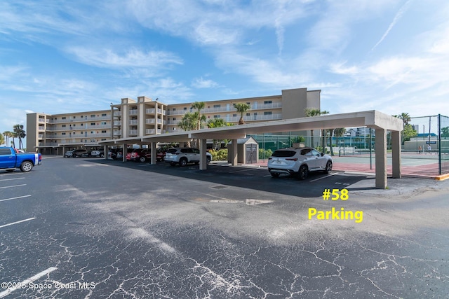 partially covered parking lot with fence