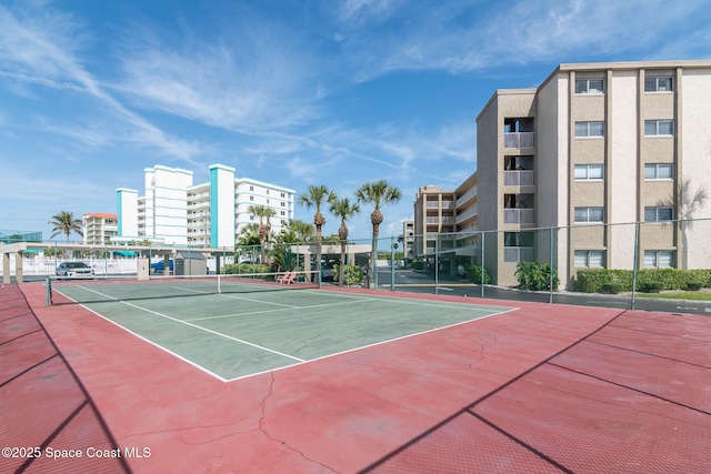 view of tennis court featuring fence