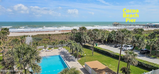 exterior space with fence and a view of the beach