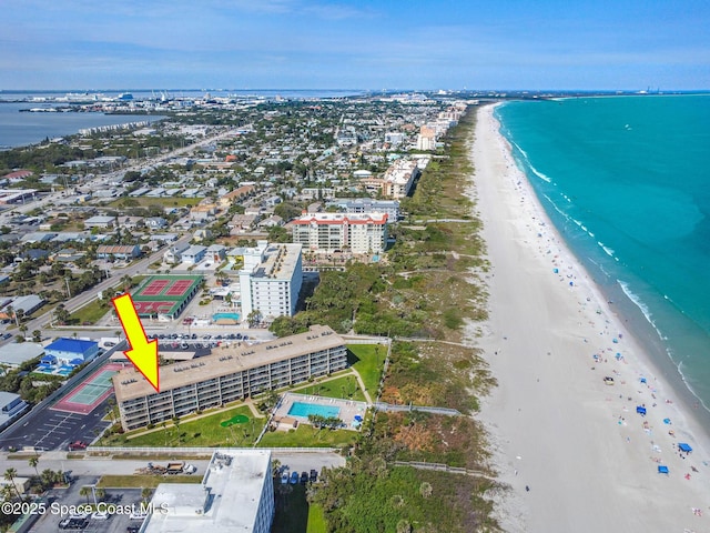 bird's eye view featuring a water view, a view of the beach, and a city view