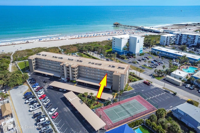 birds eye view of property with a beach view and a water view