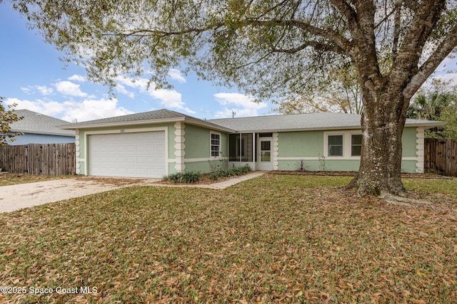 ranch-style home with stucco siding, an attached garage, a front yard, fence, and driveway