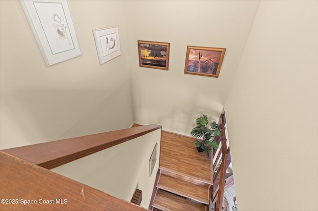 stairway featuring wood finished floors