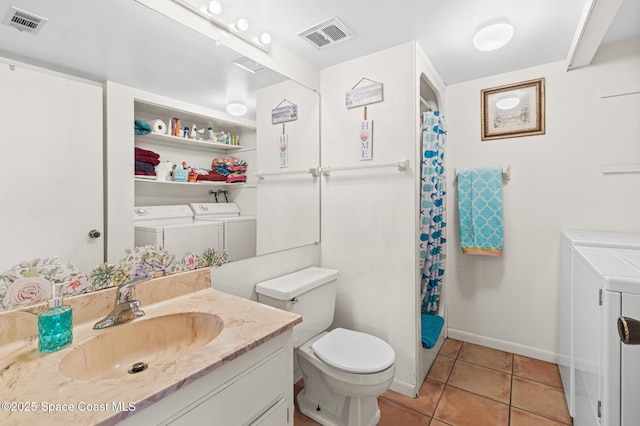 bathroom with washer and dryer, visible vents, vanity, and toilet