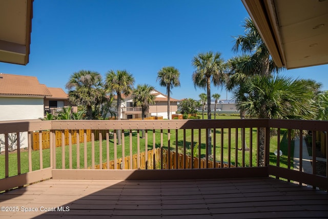 wooden deck featuring a residential view and a yard