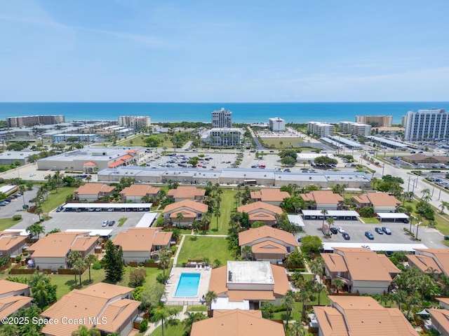 birds eye view of property with a view of city and a water view