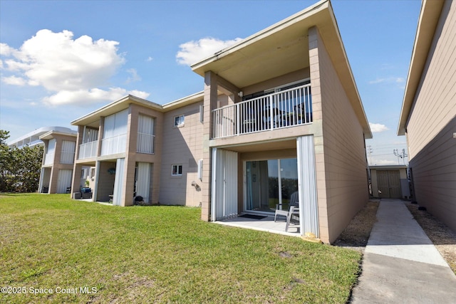 back of property featuring a yard and a patio