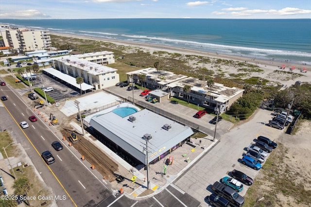 drone / aerial view featuring a water view and a beach view