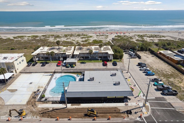 bird's eye view featuring a beach view and a water view