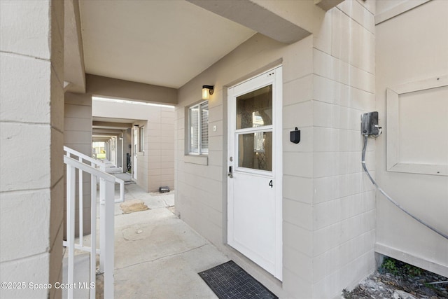 property entrance featuring concrete block siding