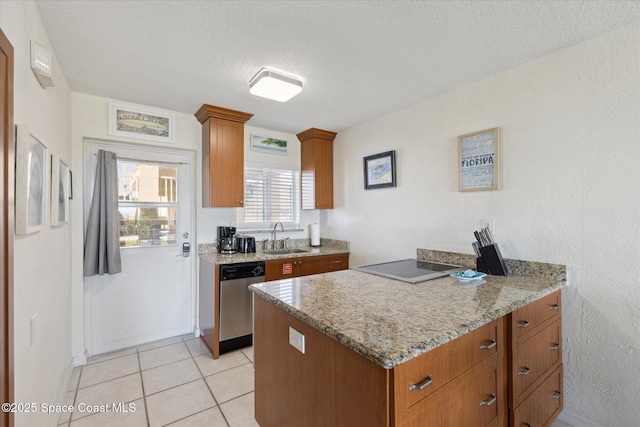 kitchen featuring brown cabinetry, a sink, stovetop, and stainless steel dishwasher