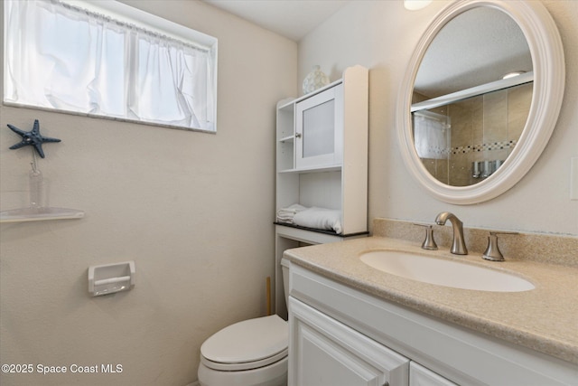 full bathroom featuring toilet, an enclosed shower, and vanity