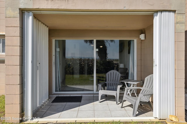 entrance to property featuring a patio area