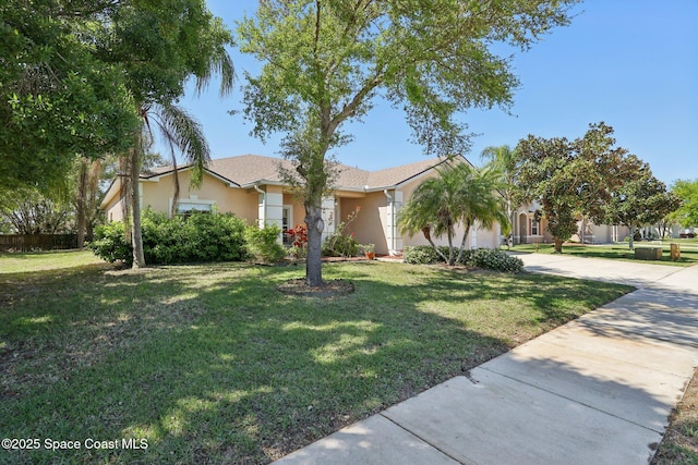 view of front of house featuring stucco siding, a front lawn, concrete driveway, and a garage