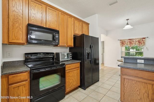 kitchen featuring dark countertops, visible vents, black appliances, and light tile patterned flooring