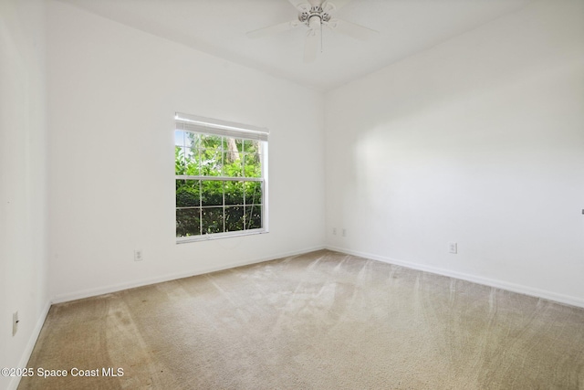 empty room featuring carpet flooring, a ceiling fan, and baseboards