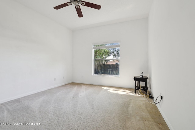 carpeted empty room with baseboards and ceiling fan