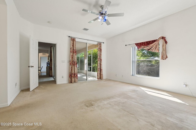 unfurnished bedroom with carpet flooring, access to exterior, multiple windows, and visible vents