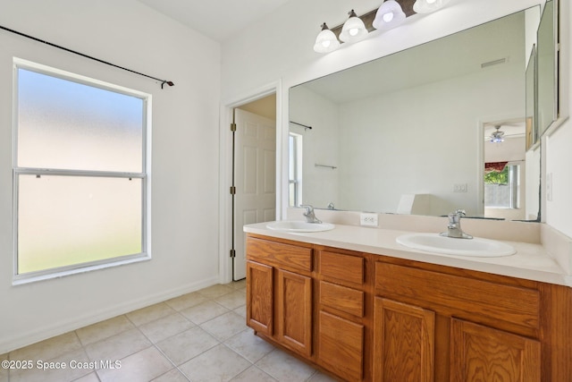 full bath with double vanity, visible vents, tile patterned floors, and a sink