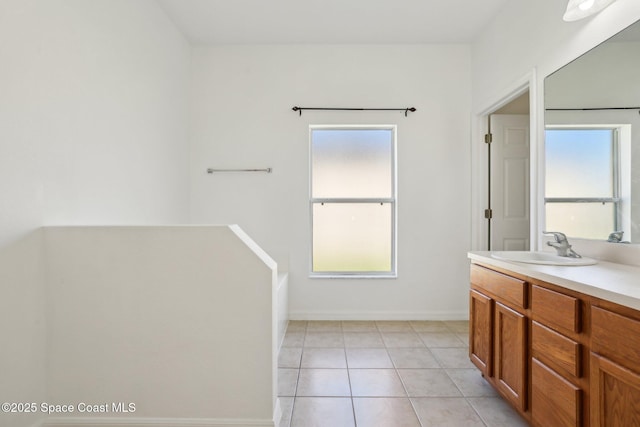 bathroom featuring a wealth of natural light, vanity, and tile patterned floors