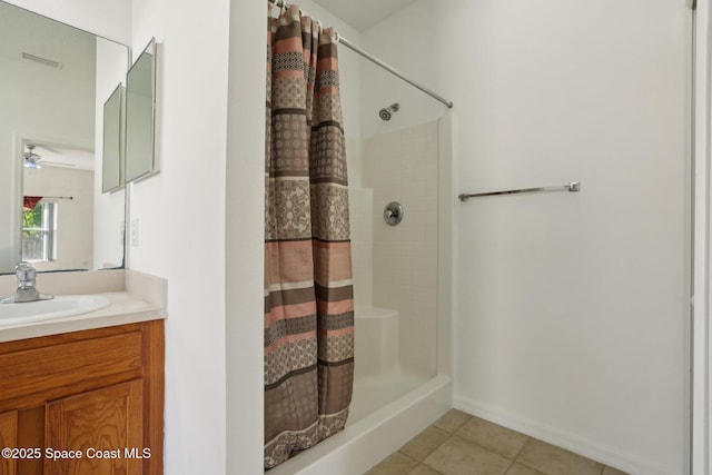 full bath with a shower with shower curtain, tile patterned floors, vanity, and a ceiling fan