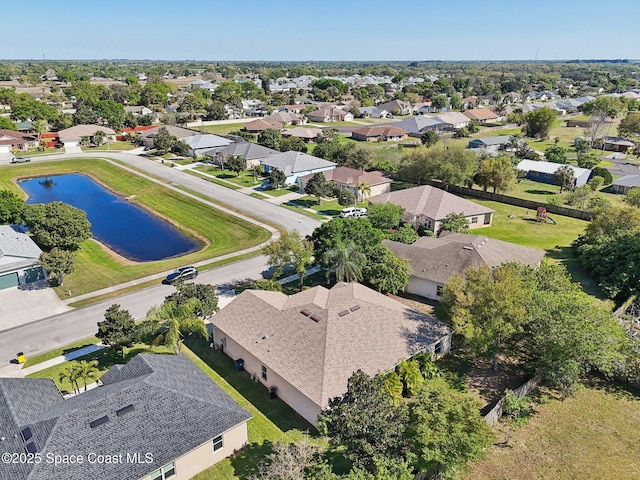 drone / aerial view with a residential view and a water view