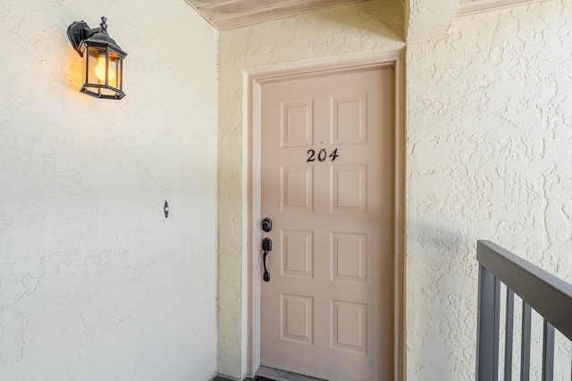 property entrance featuring stucco siding