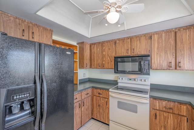 kitchen with dark countertops, black appliances, and brown cabinetry