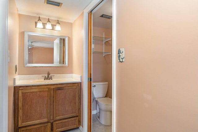 bathroom with visible vents, vanity, toilet, and tile patterned floors