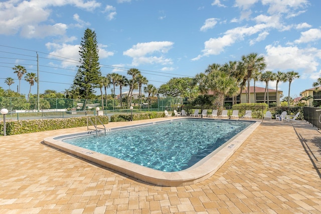 pool featuring a patio area and fence